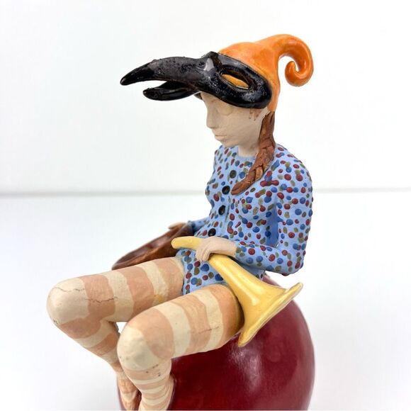 CARRIANNE L HENDRICKSON woman with beak hat sitting on apple sculpture 2… - Picture 7 of 16